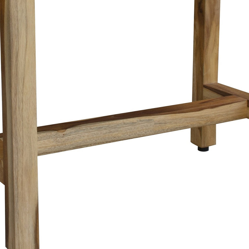 Natural teak lower shelf and supporting legs of outdoor bench, close-up.