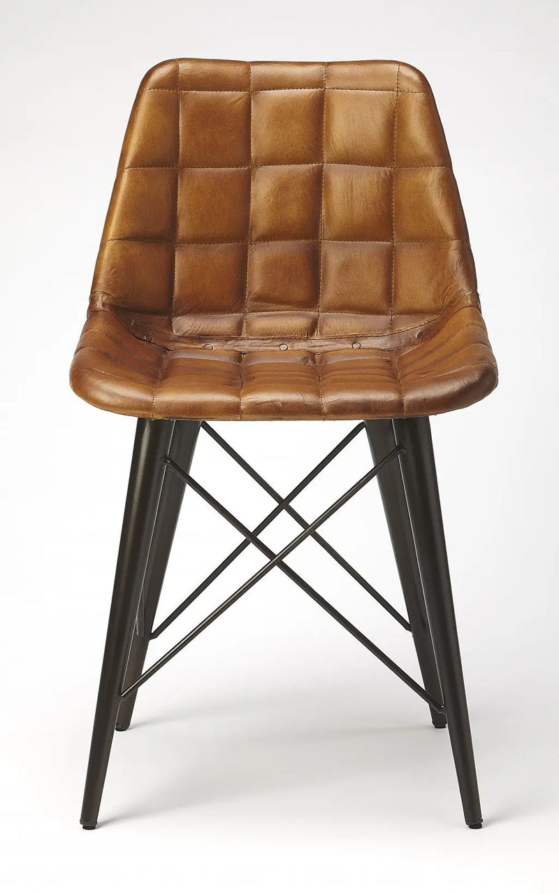 Brown leather tufted dining chair with black metal legs, featuring a stylish modern design.