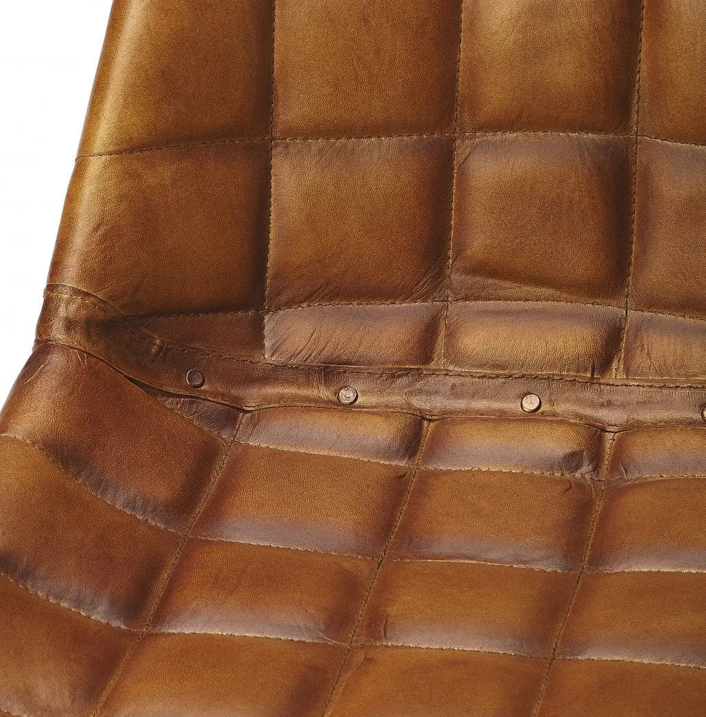 Brown leather quilted chair seat with stylish button accents for modern and vintage decor.