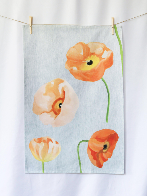 Blue tea towel with orange poppy flowers and green stems