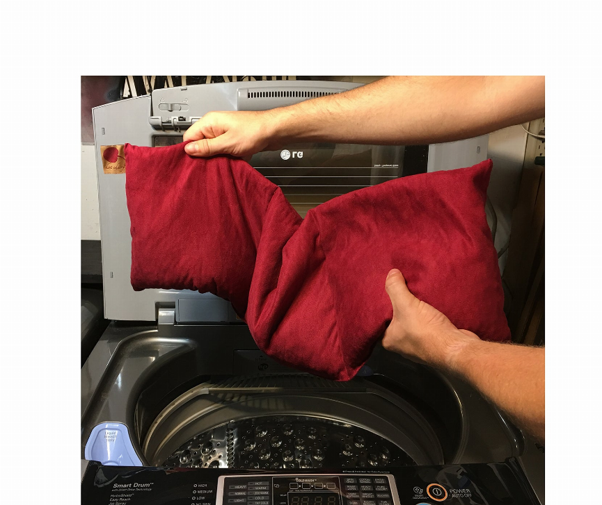 Red plush triple-square pillow, folded on a washing machine rack