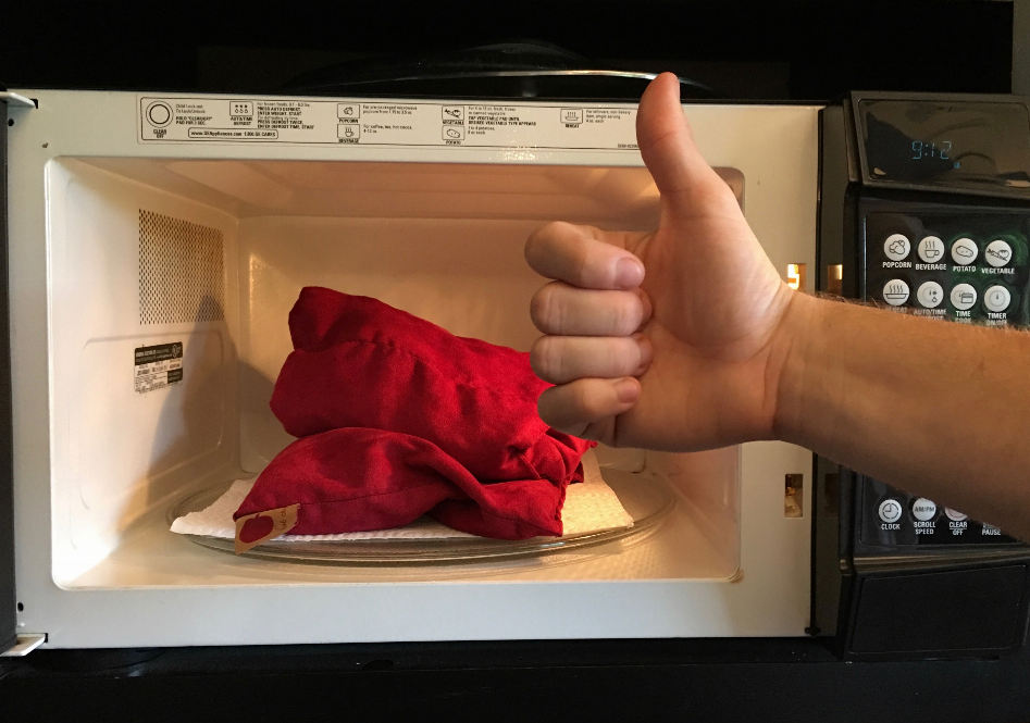 Red plush triple-square throw pillow, bunched on a plate in a microwave