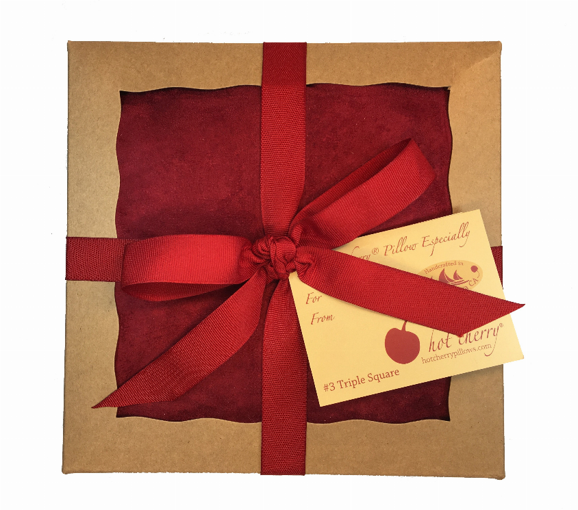 Red triple-square throw pillow gift box with ribbon and attached tag