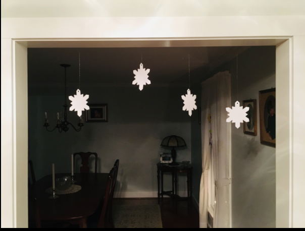 Hanging white snowflake cut-outs on strings