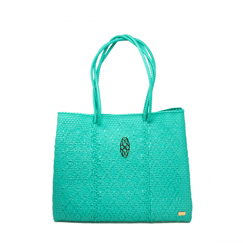 Woven aqua green travel tote with small oval emblem on the front
