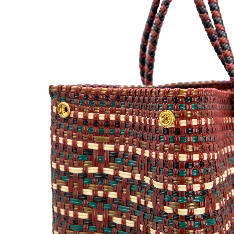 Multicolor woven travel tote with top handles and gold snap hardware