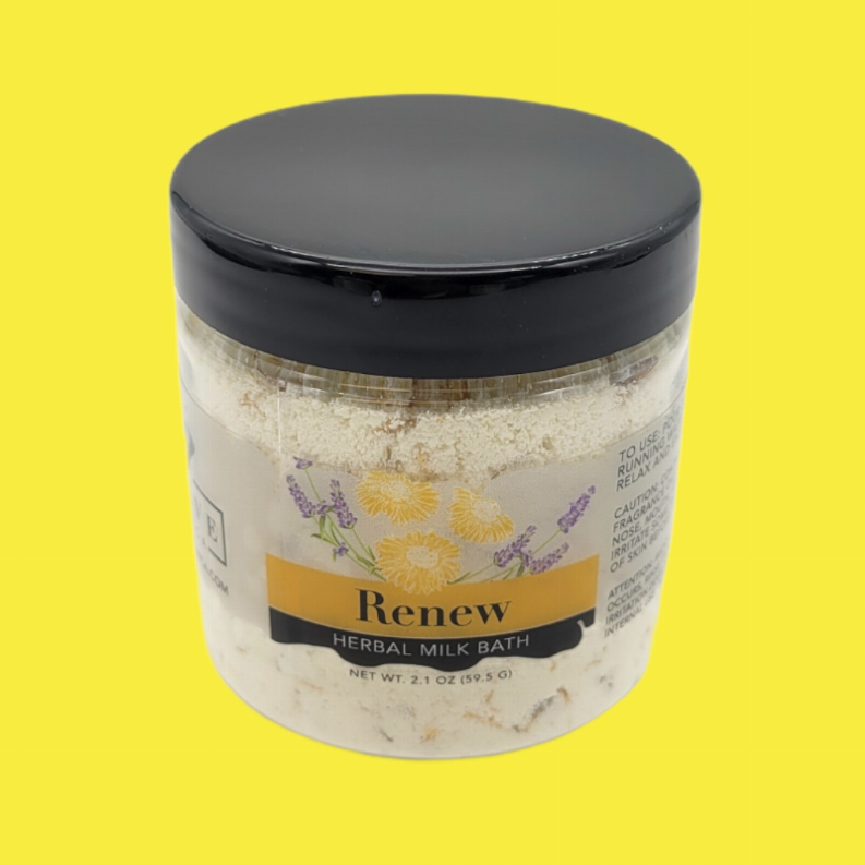 Milk bath soak jar with herbal renew label, black lid, pale powder inside.