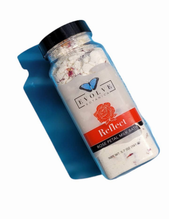 Milk bath soak bottle with butterfly rose petal label, black cap, pale powder contents.