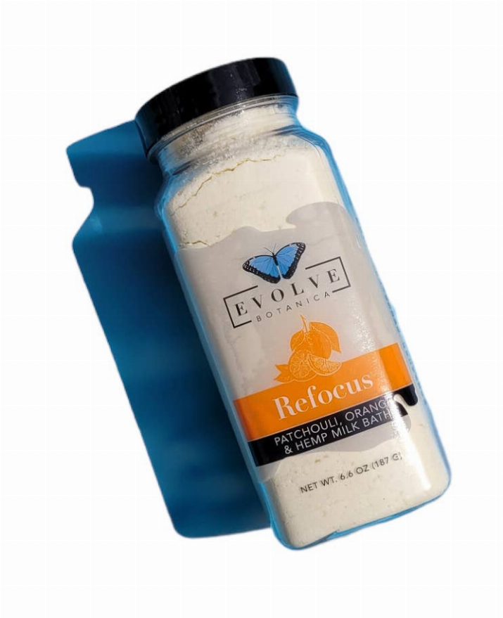 Refocus milk bath bottle with orange patchouli hempseed oil label