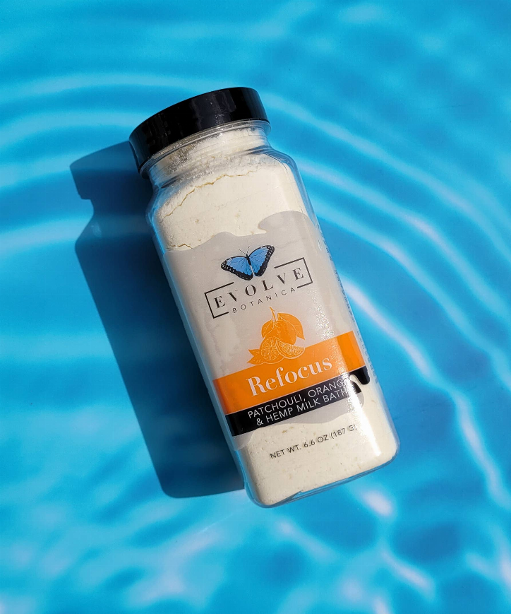 Front label Refocus milk bath bottle, orange patchouli and hempseed oil