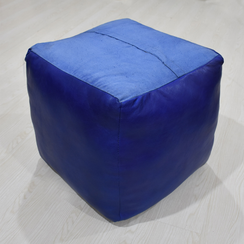 Square blue leather pouf with stitched top panel and smooth rounded edges.