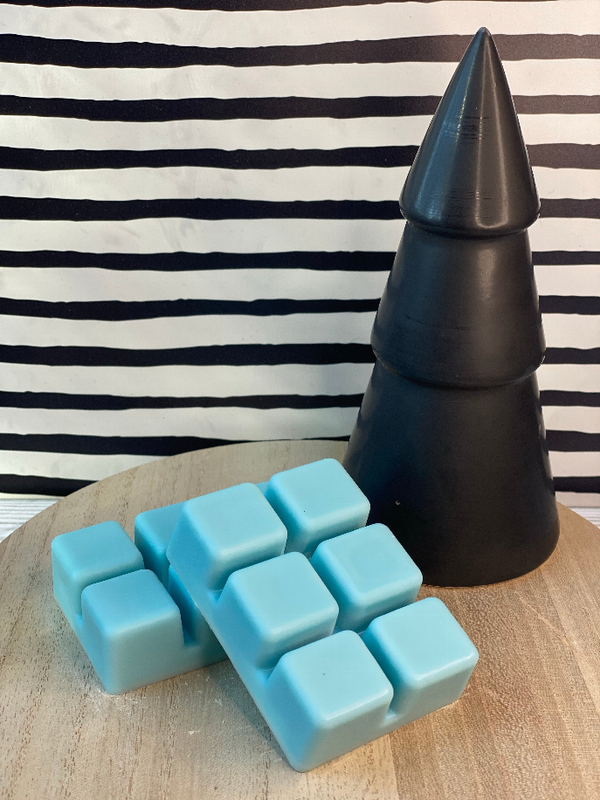 Blue wax melt cubes in a clear tray, with a black wax warmer cone