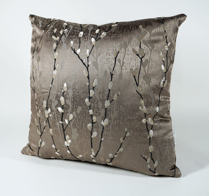 Taupe throw pillow cover with white branch pattern and subtle speckled background texture.