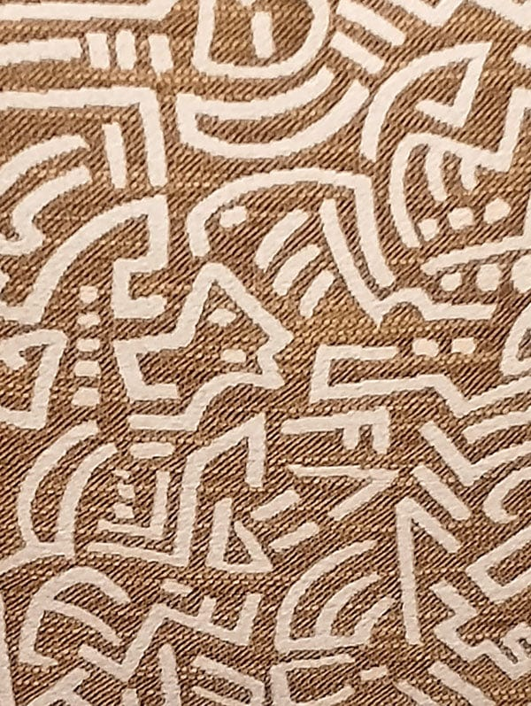 Pop Energy throw pillow close-up on tan fabric with white abstract line maze