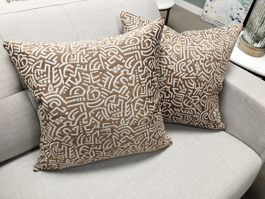 Pop Energy throw pillow in tan with white abstract line pattern