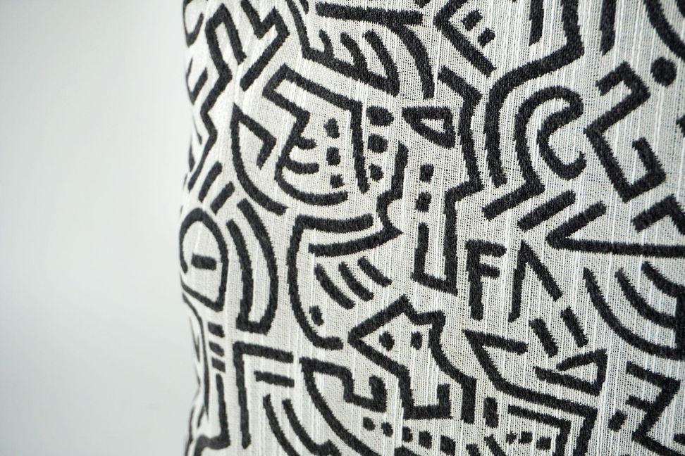 Cream throw pillow cover with black geometric maze line pattern