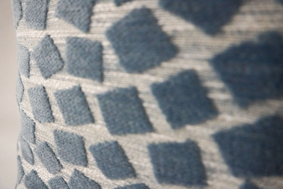 Blue and cream geometric pattern throw pillow fabric with raised square texture