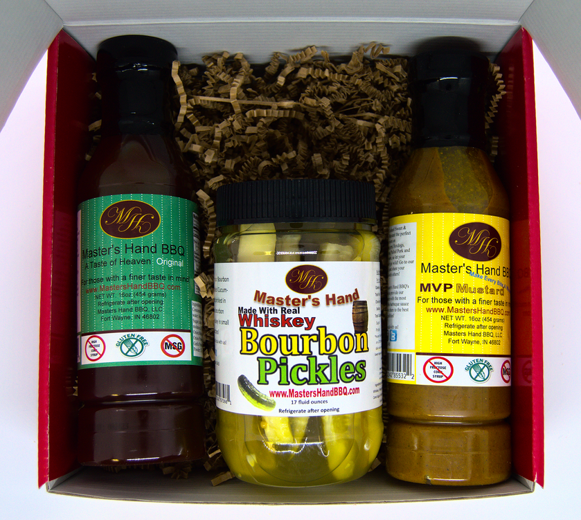 Gift set in open red box with BBQ sauce bottle, bourbon pickles jar, and dressing bottle