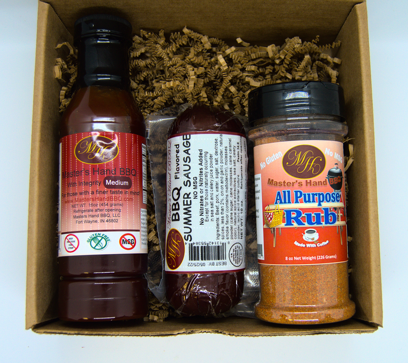 BBQ sauce, sausage, and seasoning rub bottles in a kraft gift box