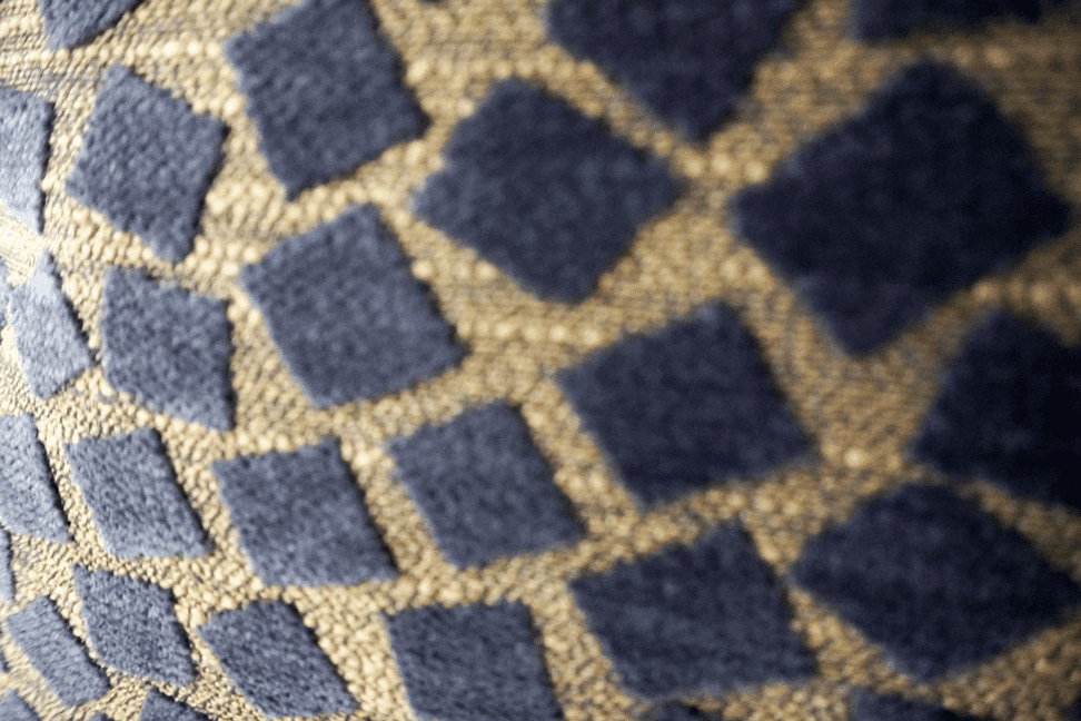 Close-up of navy and light beige geometric mosaic pattern throw pillow fabric