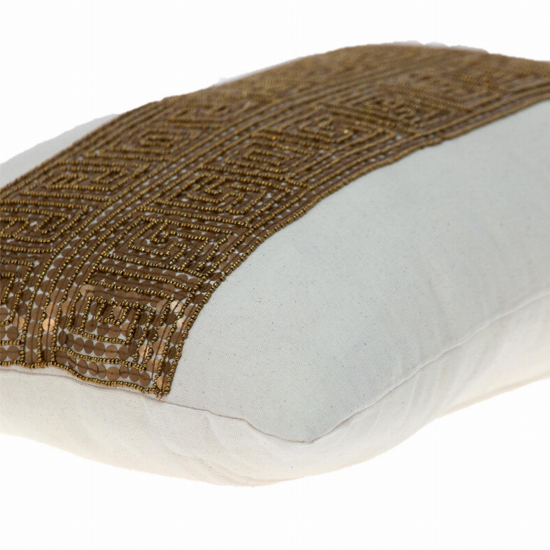 Lumbar throw pillow corner with gold-brown geometric embroidered band detail