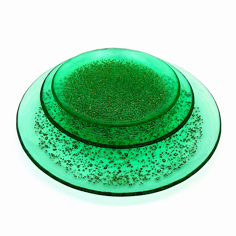 Emerald glass dinner plate set with gold speckled surface, top plate centered.