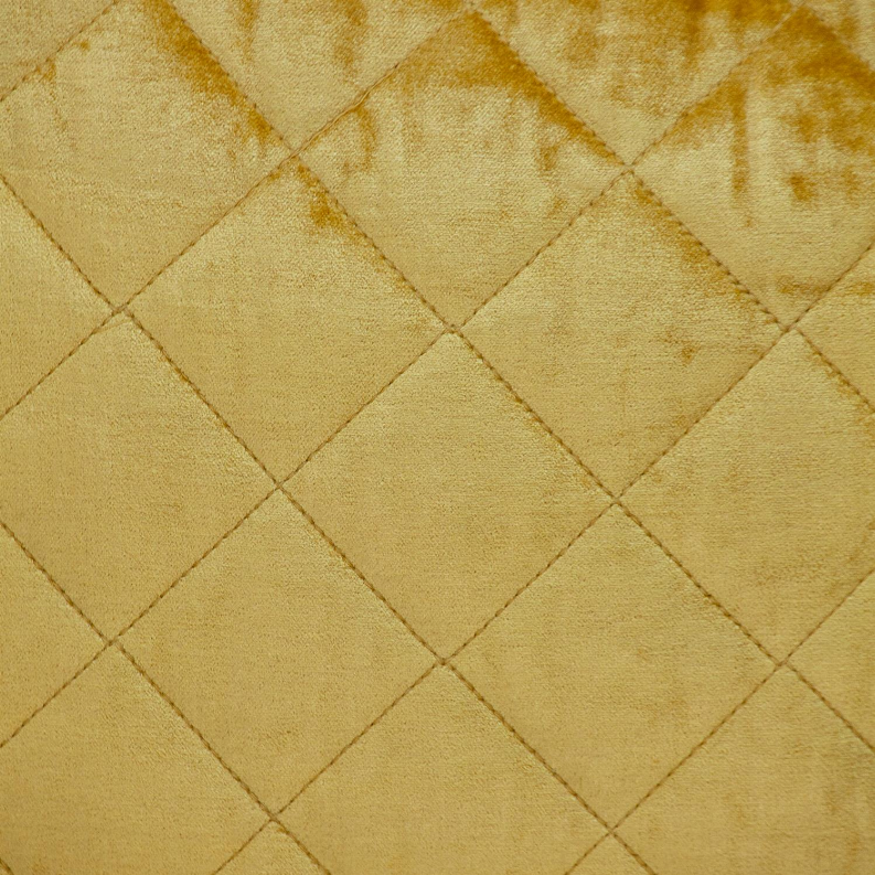 Yellow quilted throw pillow with diamond stitch pattern texture close-up
