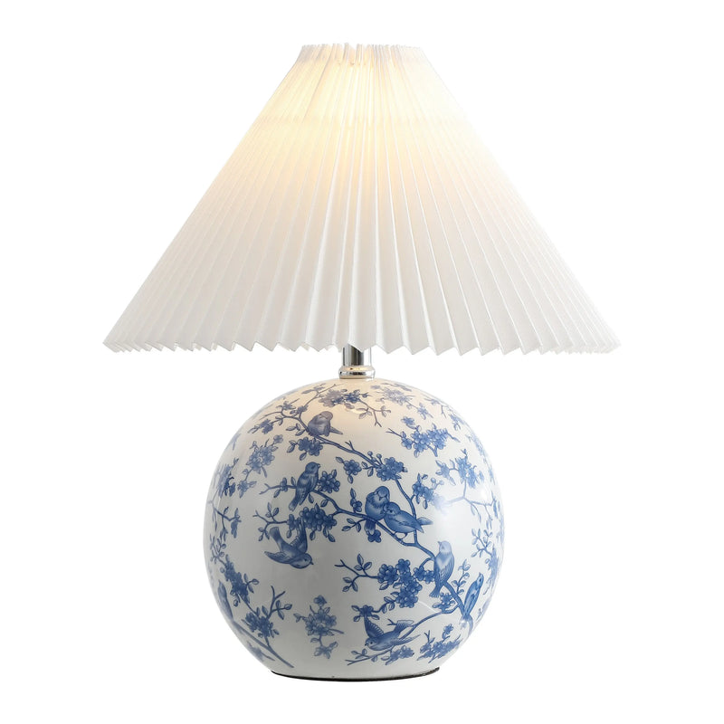 Blue and white porcelain table lamp with a pleated white shade and floral design, perfect for elegant decor.
