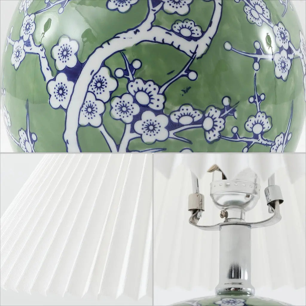 Green ceramic lamp with blue floral design and white pleated shade, elegant accent for modern decor.