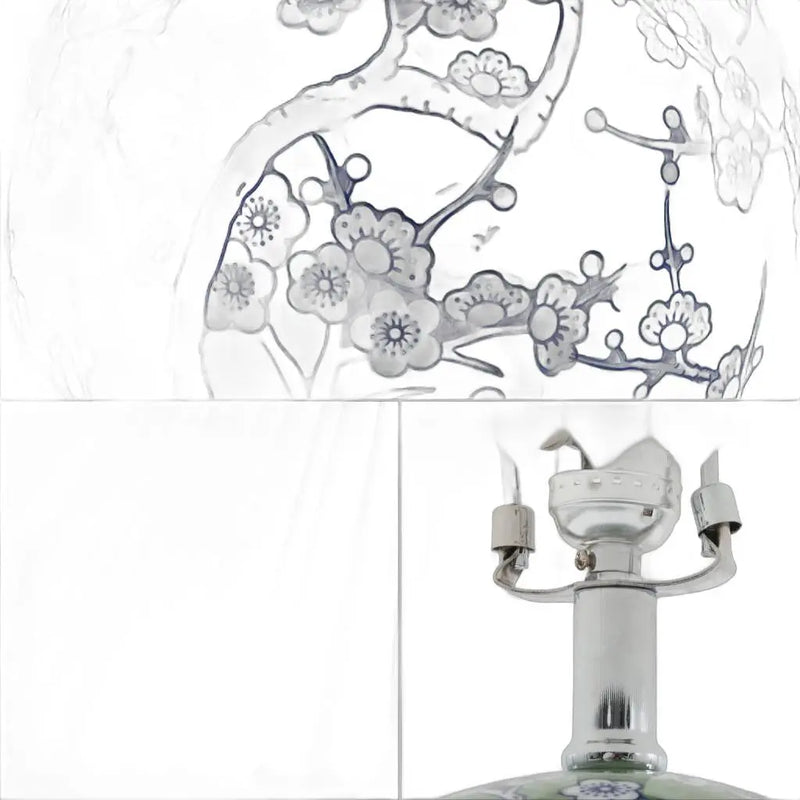 Ceramic table lamp with blue floral design on clear glass, featuring a polished silver base and socket.