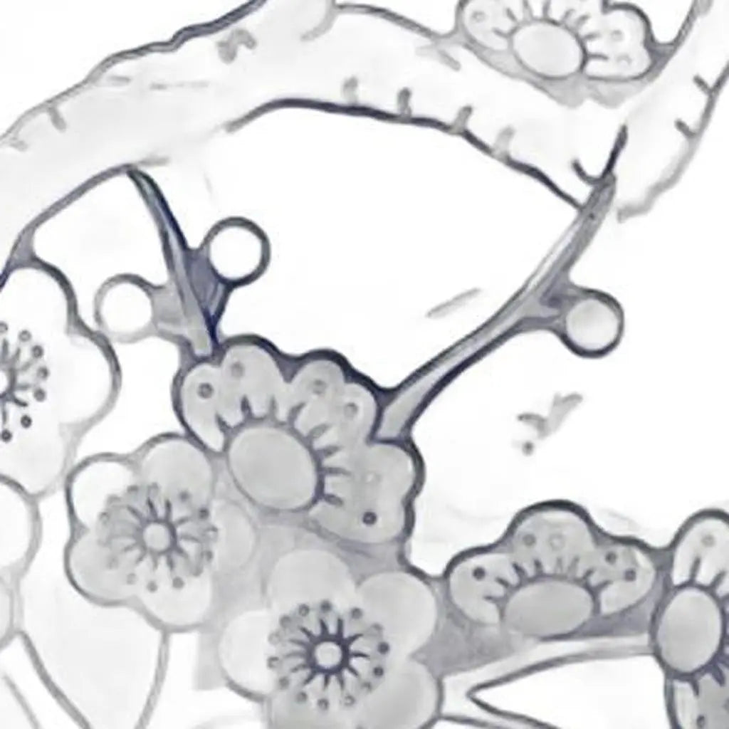 Delicate white floral lace fabric with intricate black designs, perfect for elegant dressmaking or crafting projects.
