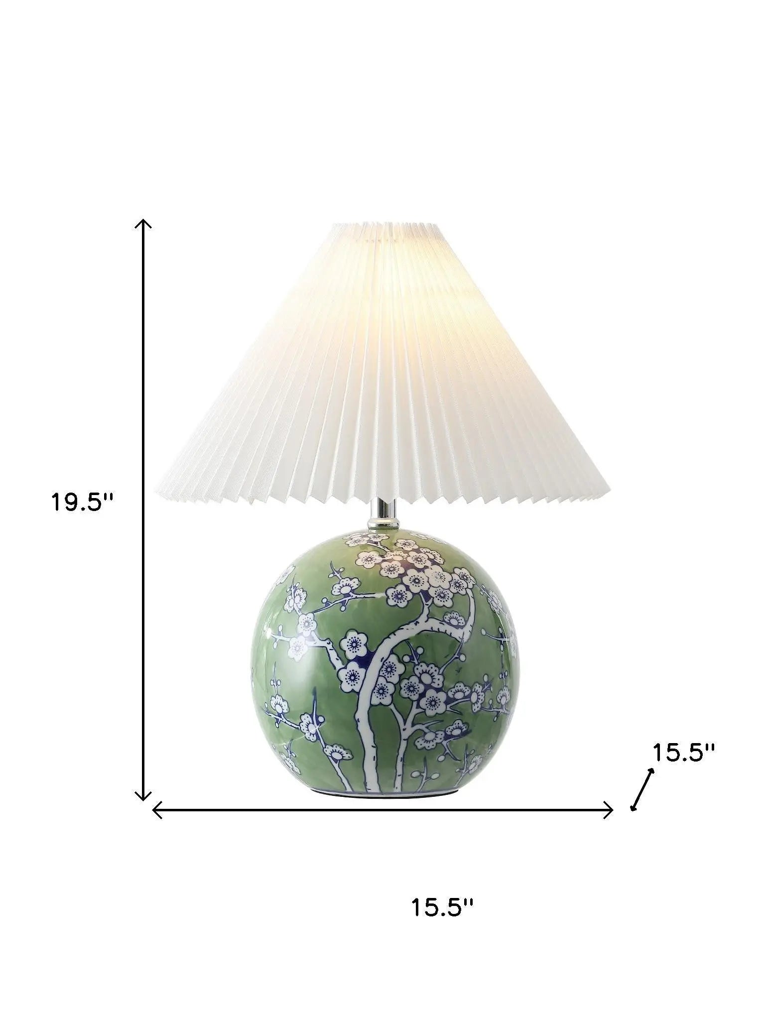 Green ceramic lamp with floral design and white pleated shade, height 19.5", width 15.5". Perfect for stylish decor.
