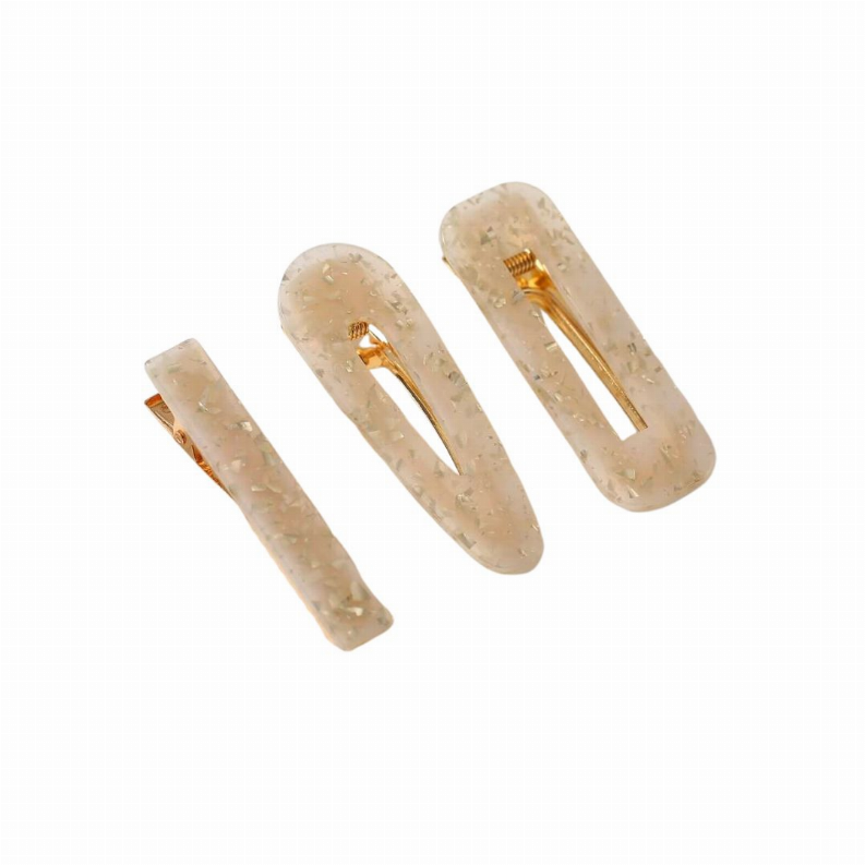 Three sparkle resin hair clips, translucent gold-beige with gold prongs.