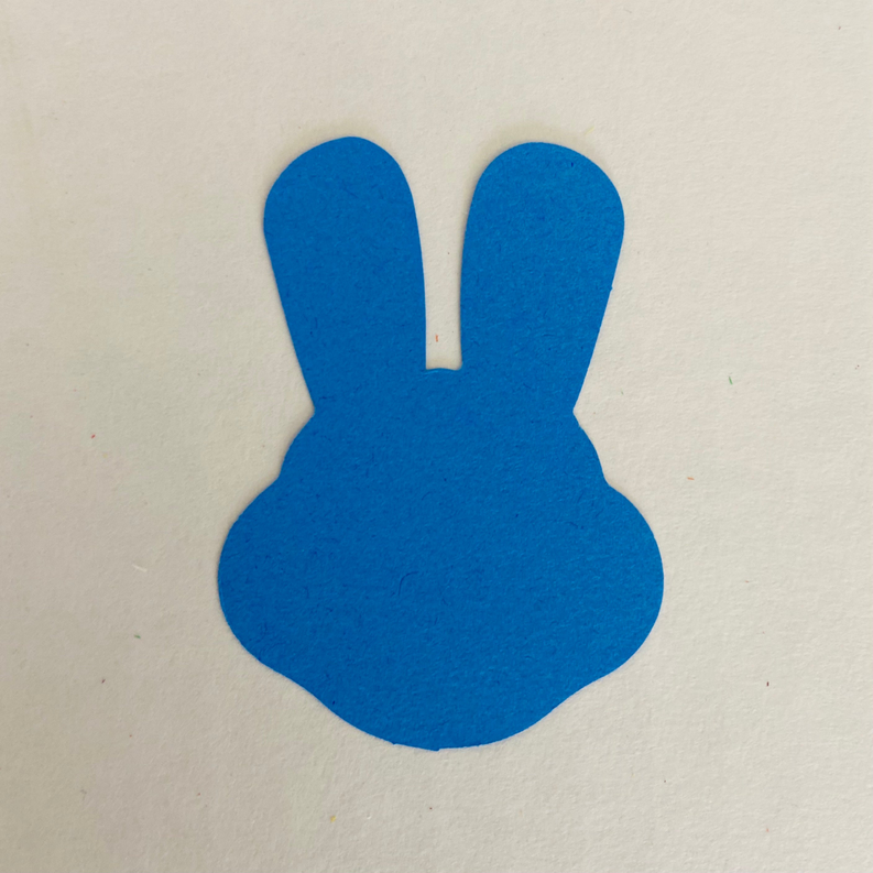 Blue bunny cut-out with two upright ears and rounded body silhouette