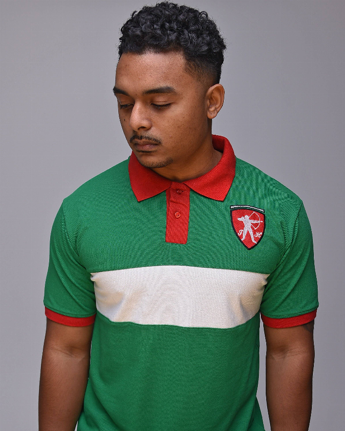 Kelly green classic polo shirt with red collar, white stripe, and shield logo