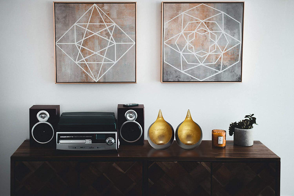 Gold-and-black teardrop tea light candle holders displayed on a table