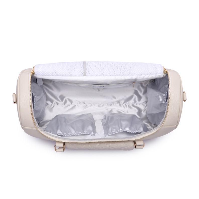 Pearl white travel bag open interior with quilted lining and zippered compartments