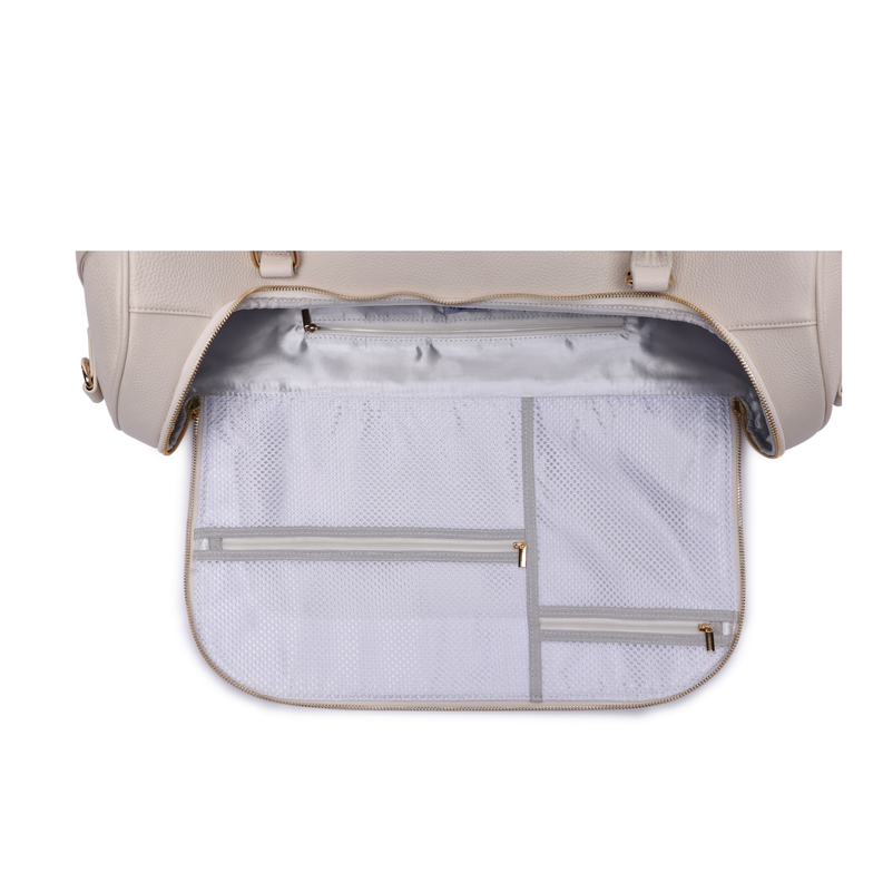 Pearl white travel bag interior with zippered mesh pockets and divider