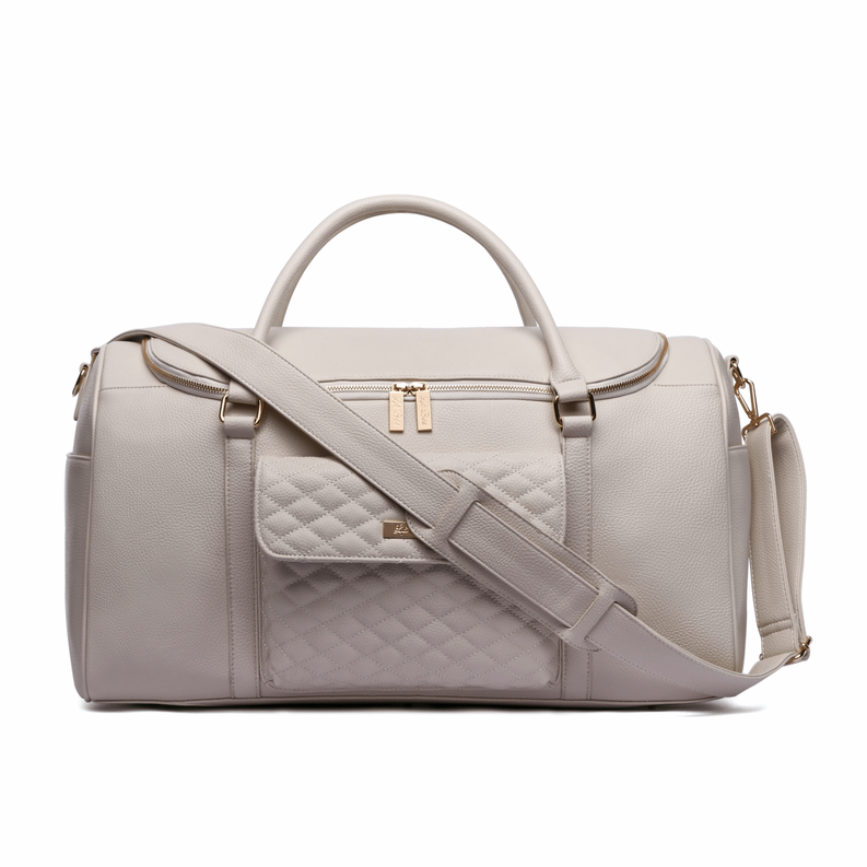 Pearl white travel bag side view with crossbody strap and quilted front panel