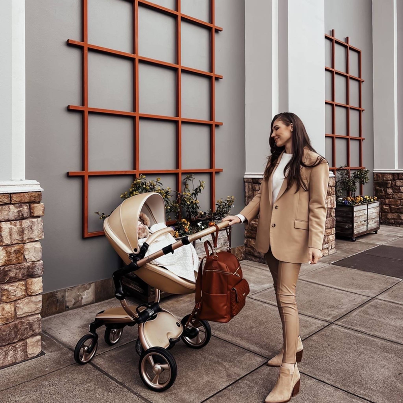 Caramel brown diaper bag backpack with short handles and front zip pocket