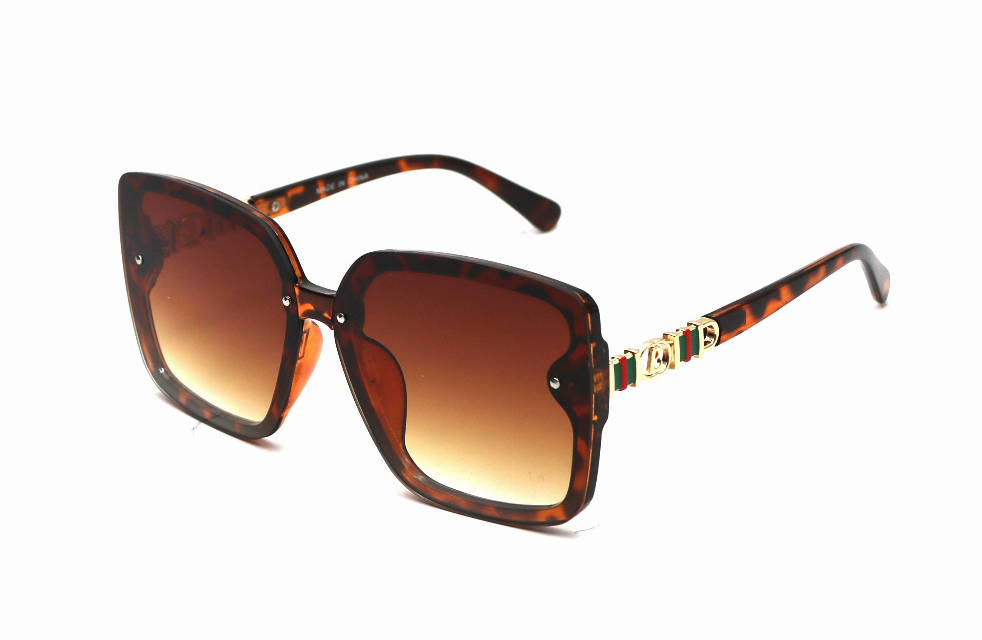 Tortoiseshell sunglasses with amber tinted lenses and decorative gold-toned temple detail