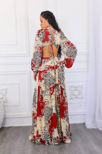 Back view of ruffle-trim maxi dress with lace-up cutout, red cream black floral print.