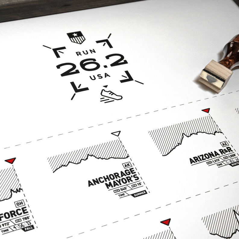 Marathon route register print featuring “RUN 26.2 USA” text and arrows over map layout.