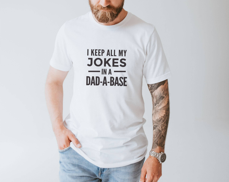 White dad joke T-shirt with 'JOKES IN A DAD-A-BASE' print