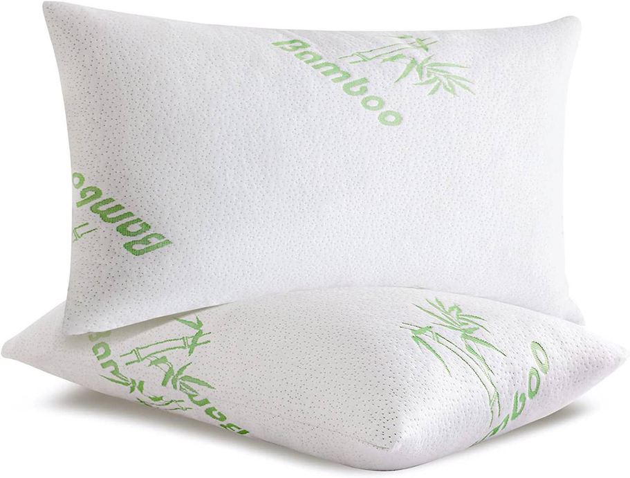 Support pillow pair with white covers and green bamboo graphic print, angled view.