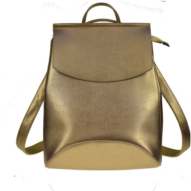 Gold-tone leather backpack with curved front flap and shoulder strap handles