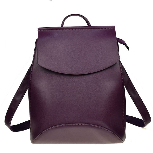Dark purple leather backpack with front flap and top handle, crossbody straps