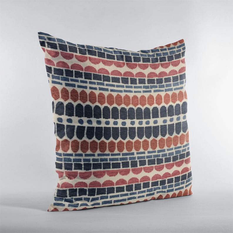 Red, navy, and cream brick-pattern throw pillow standing upright on a white background.