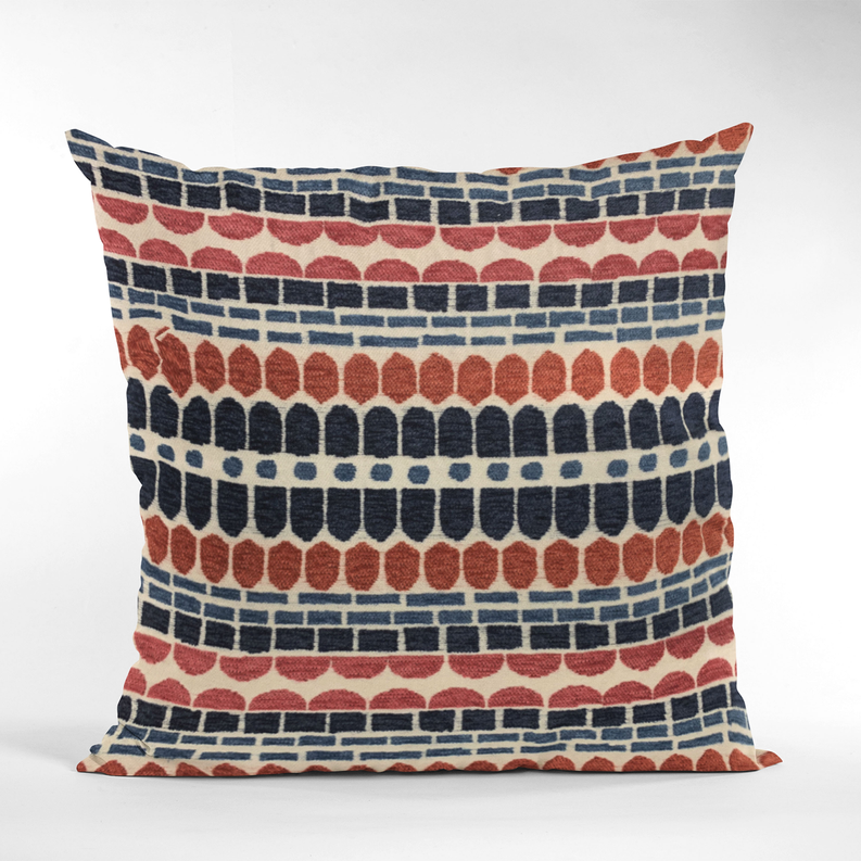 Red, navy, and cream brick-pattern throw pillow viewed from the side.