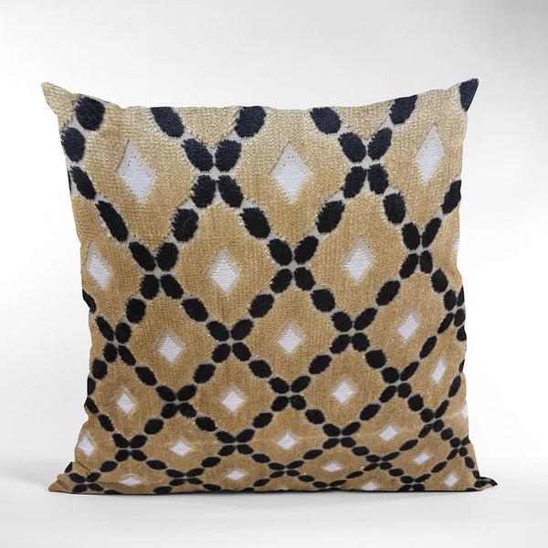 Geometric velvet decorative pillow in gold, cream, and black with diamond trellis pattern